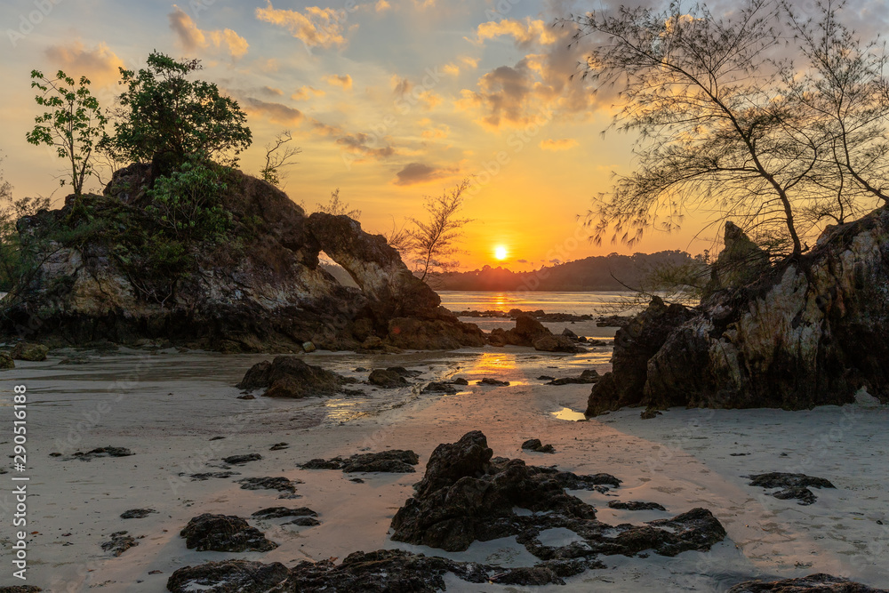 Rocky tropical coastline at sunset
