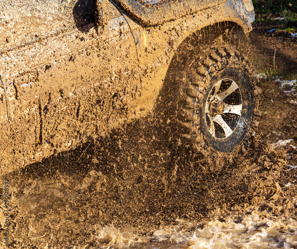 SUV wheel stalled in mud and water