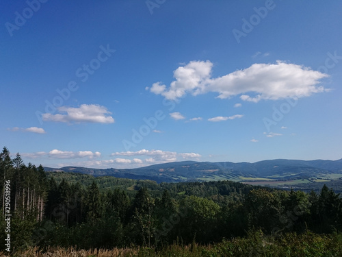 Summer landscape in mountains and the dark blue sky with clouds