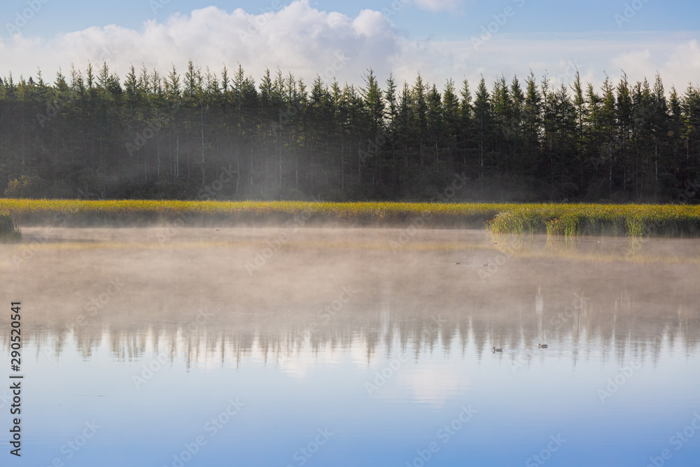 Fototapeta premium Mist rising over a still waters.