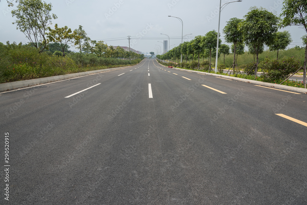 Urban asphalt road and green perspective