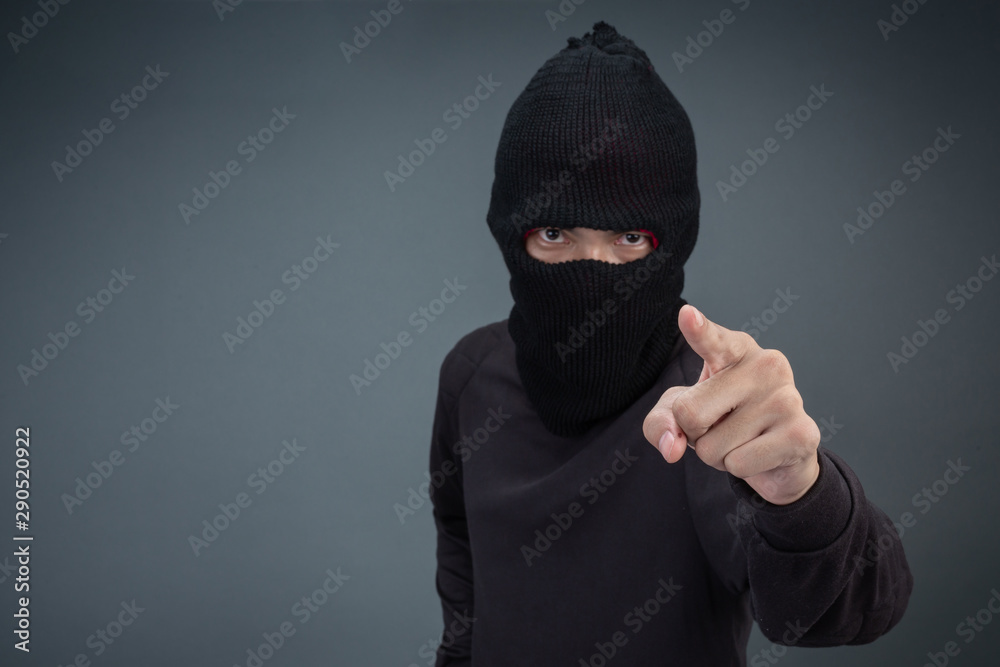 Criminals wear a mask in black on a gray background. Criminals wear a mask in black on a gray background.