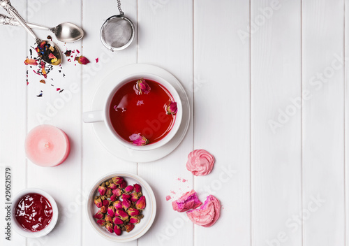 Fototapeta Naklejka Na Ścianę i Meble -  Floral tea with roses and other tea time accessories on white wooden table