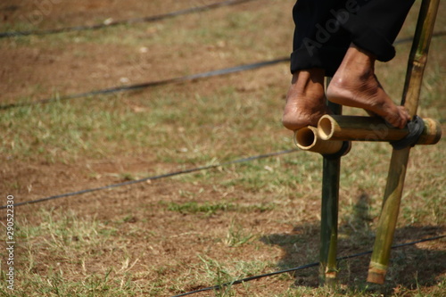 Batang, Central Java / Indonesia - September 16 2019 : Play egrang, a traditional game from Indonesia.