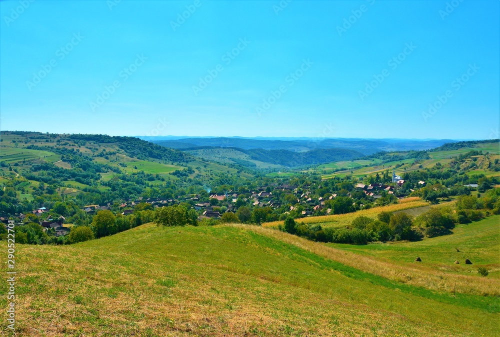 a village between the hills of Transylvania seen from above