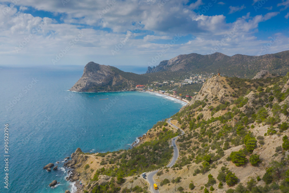 Aerial view of serpentine road in green mountains and sea, Black Sea, Novyi Svit, Crimea Aerial view of serpentine road in green mountains and sea, Black Sea, Novyi Svit, Crimea