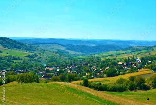 a village between the hills of Transylvania seen from above