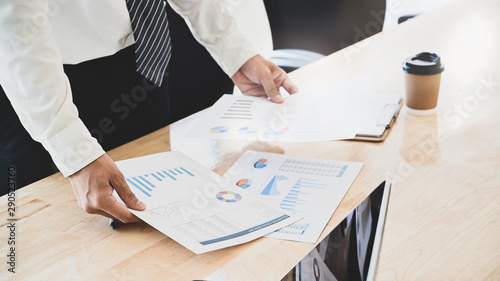 Принти на полотні Businessman compare finance data on table.
