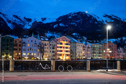 Winter Innsbruck by night. Colorful bright lightning building and mountines, covered with snow. Austria, Tyrol. 