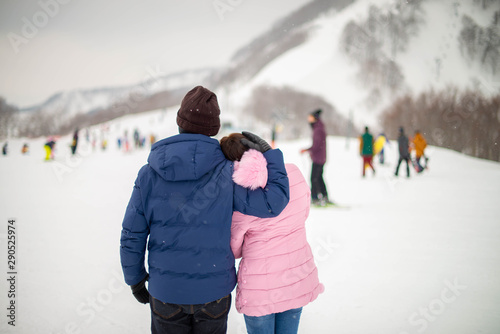 Young romantic couple is having fun outdoors in winter ski. Enjoying spending time together.