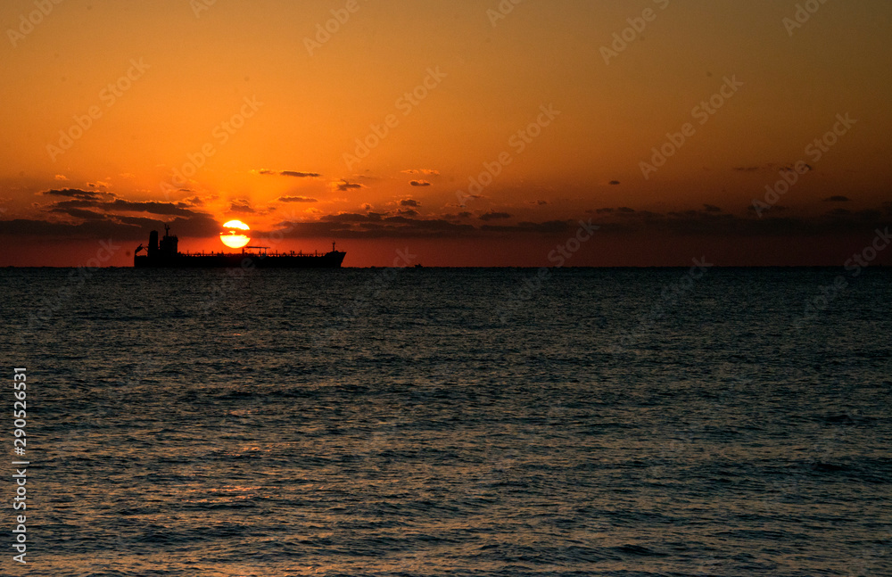 Sunrise at the Fort Lauderdale beach near Miami in Florida with sun coming out from behind a ship
