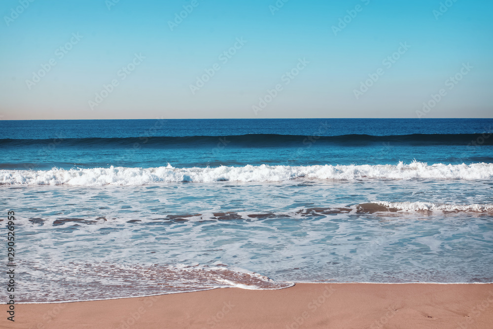 Empty ocean beach with small waves and foam. Empty ocean beach with small waves and foam.