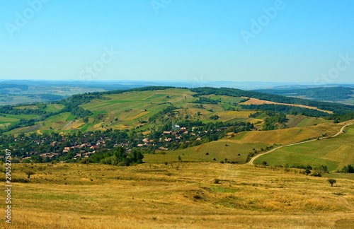 a village between the hills of Transylvania seen from above © sebi_2569