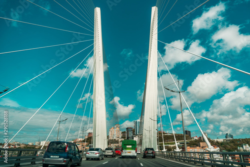 Tall white curtain car bridge with road