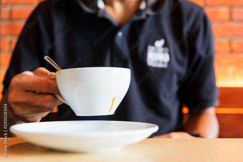 The man hold hot coffee in hand The man hold hot coffee in hand