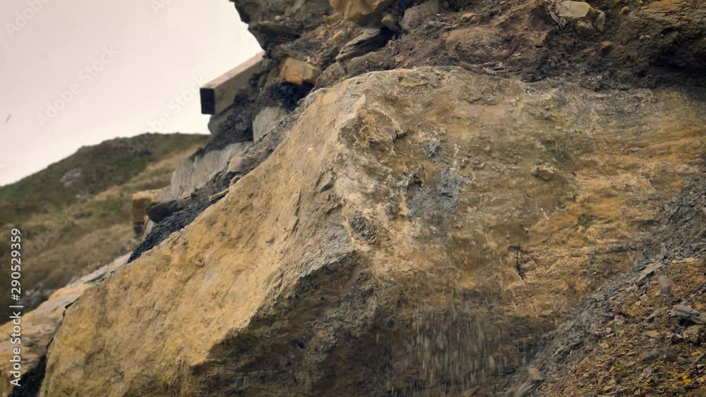 Slowmo, A piece of shale rock smashes against a boulder turns into small fragments. Slowmo, A piece of shale rock smashes against a boulder turns into small fragments.
