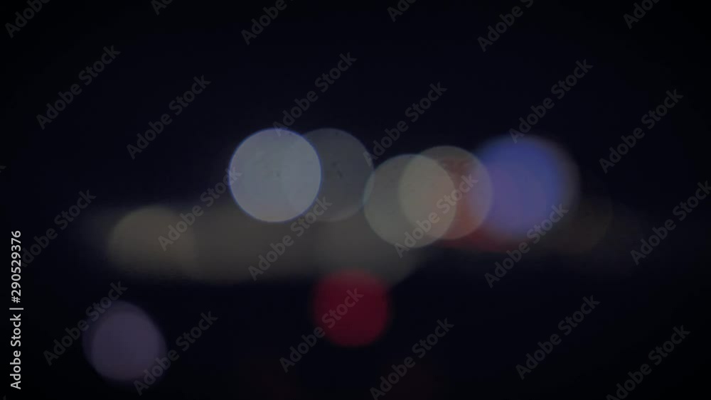 Blurred windshield view of lights from moving traffic along a highway for background use. Blurred windshield view of lights from moving traffic along a highway for background use.