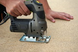 carpenter working with an electric jigsaw