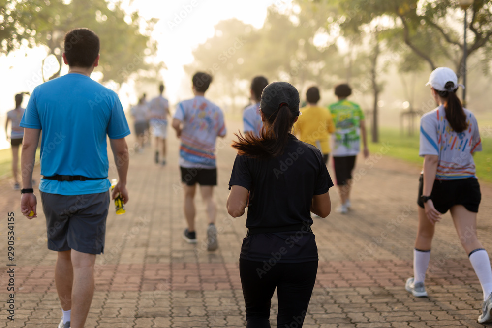 Group of people exercise in the park in morning.