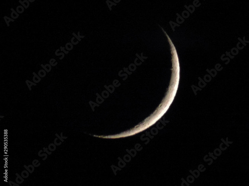 Crescent moon in the dark night sky.