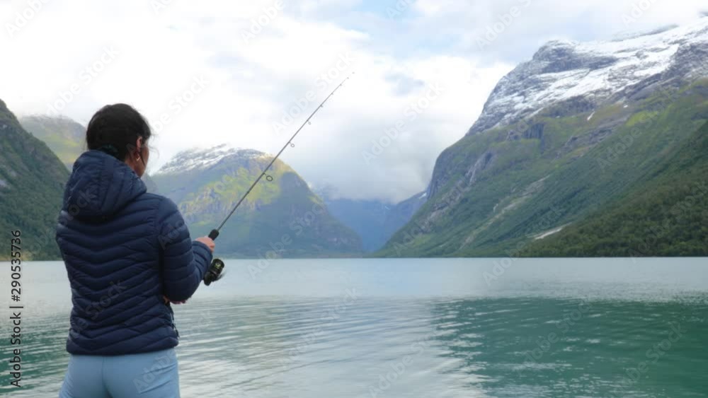 Woman fishing on Fishing rod spinning in Norway. Woman fishing on Fishing rod spinning in Norway.