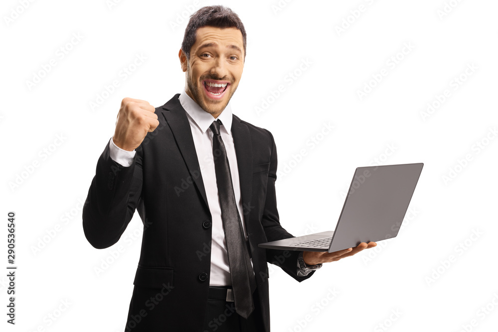 Young businessman gesturing yeah and holding a laptop computer Young businessman gesturing yeah and holding a laptop computer