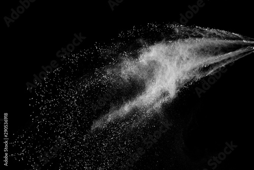Freeze motion of white color powder exploding on dark background. 