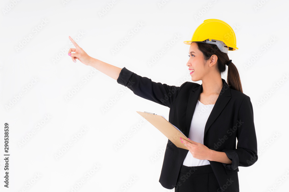 Asian young engineer women Yellow Safety helmet with clipboard and document in hand Construction and architectural industry One hand is pointing out something a copy space isolated on white background Asian young engineer women Yellow Safety helmet with clipboard and document in hand Construction and architectural industry One hand is pointing out something a copy space isolated on white background