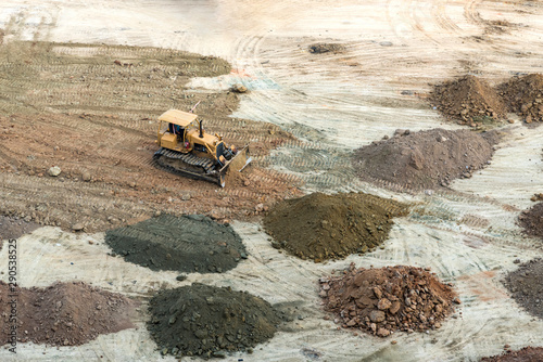 Grader, heavy truck working on construction site