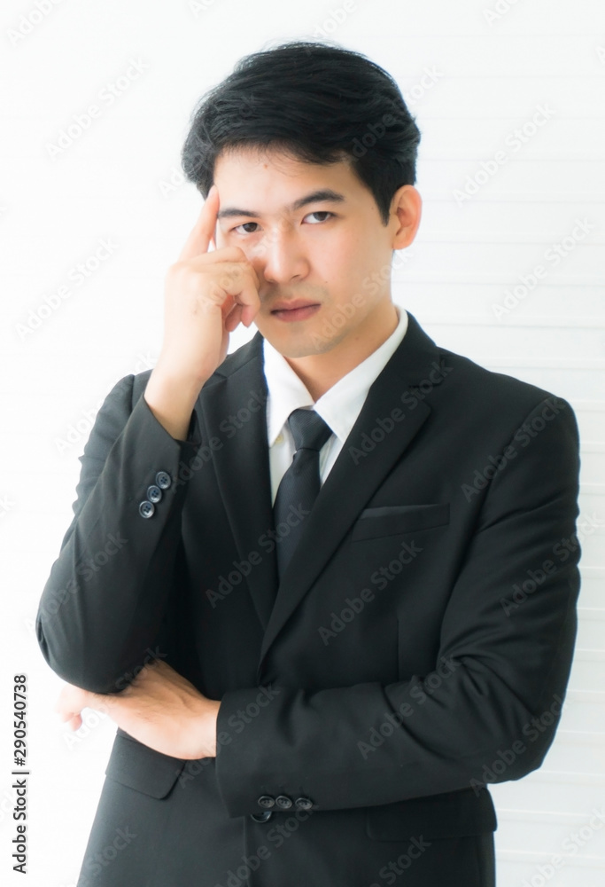 Portrait business man standing Serious with hands on face wearing a black suit Isolated on white background Portrait business man standing Serious with hands on face wearing a black suit Isolated on white background