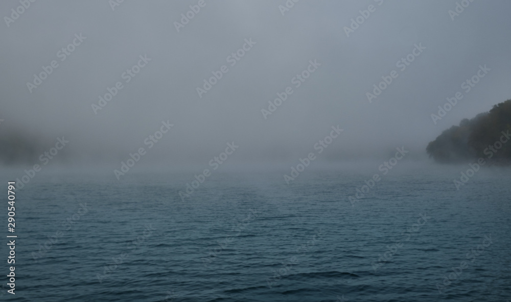Naklejka premium Autumn lake in Kamchatka is covered with fog. Lake Kamchatka autumn