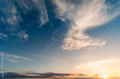 Dramadic Sunset Sky blue and orange light of the sun through the clouds in the sky