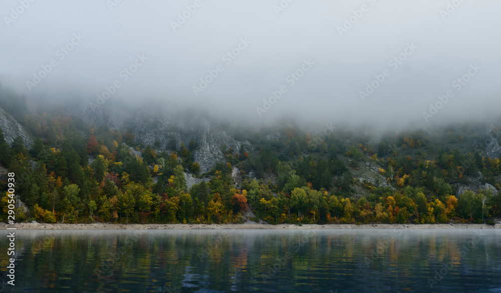 Autumn lake in Kamchatka is covered with fog. Lake Kamchatka autumn Autumn lake in Kamchatka is covered with fog. Lake Kamchatka autumn