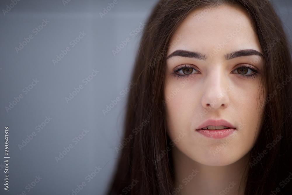 front portrait of beautiful young woman with serious expression on face front portrait of beautiful young woman with serious expression on face