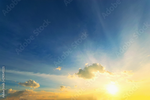 Dramadic Sunset Sky blue and orange light of the sun through the clouds in the sky photo