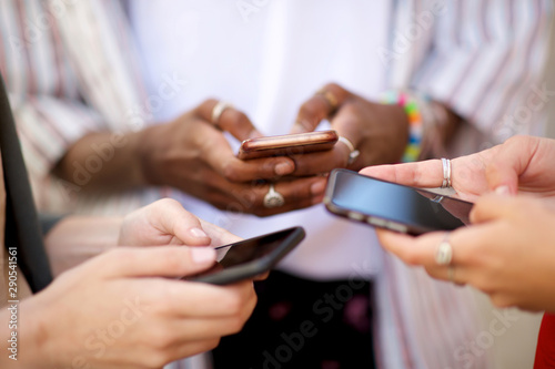 female hands holding mobile phones