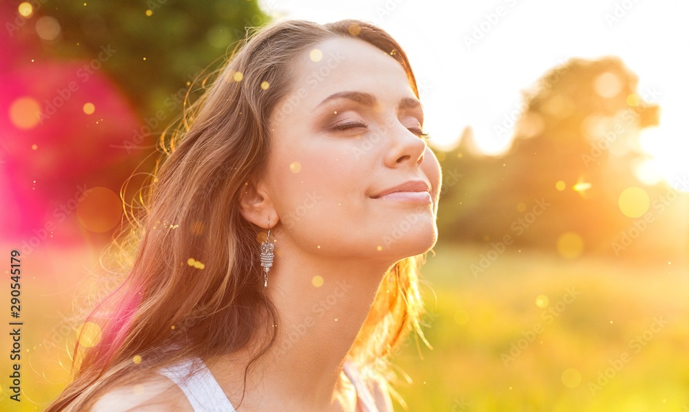 Young woman on field under sunset light Young woman on field under sunset light