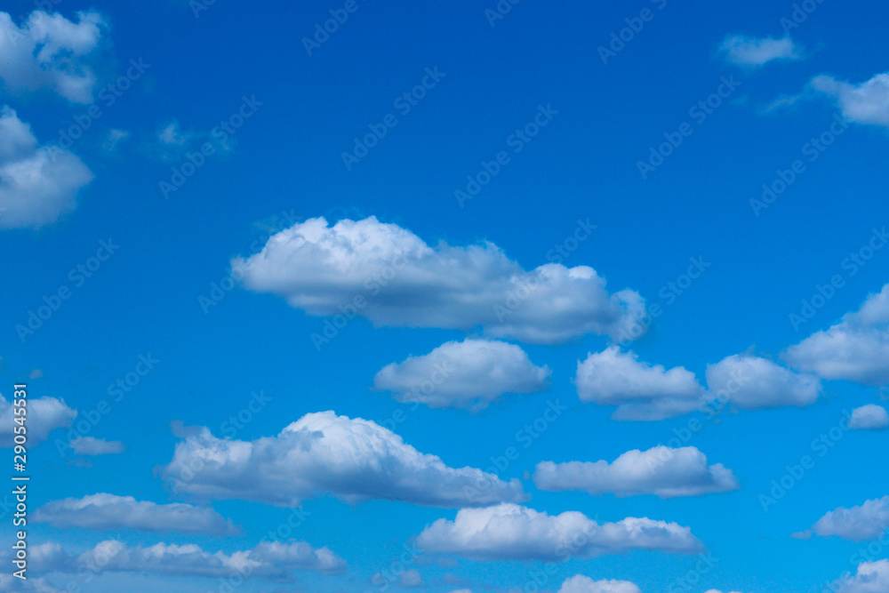 White clouds in the blue sky. Beautiful nature background. Freedom, nature, landscape concept. White clouds in the blue sky. Beautiful nature background. Freedom, nature, landscape concept.