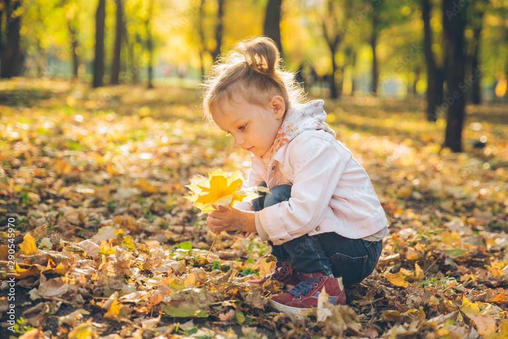 mather with little toddle daughter playing in autumn city public park mather with little toddle daughter playing in autumn city public park