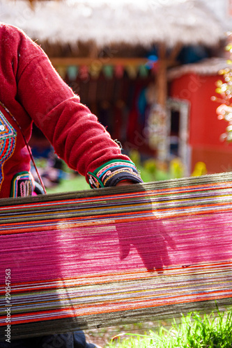 Woman showing dyed fabrics in Peru