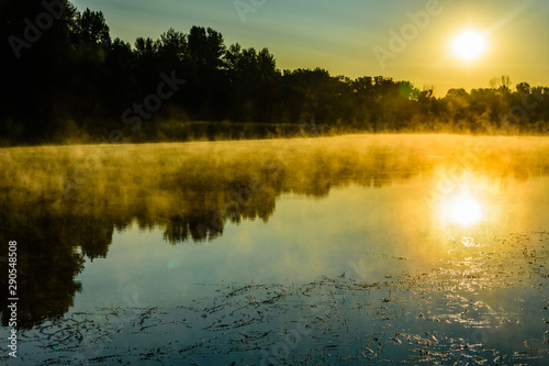 Fototapeta Naklejka Na Ścianę i Meble -  Fog above the water surface. Sunrise at river