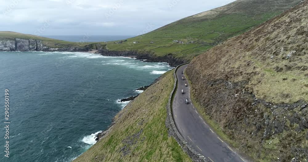 Aerial, coastal motorcycle drive in Ireland