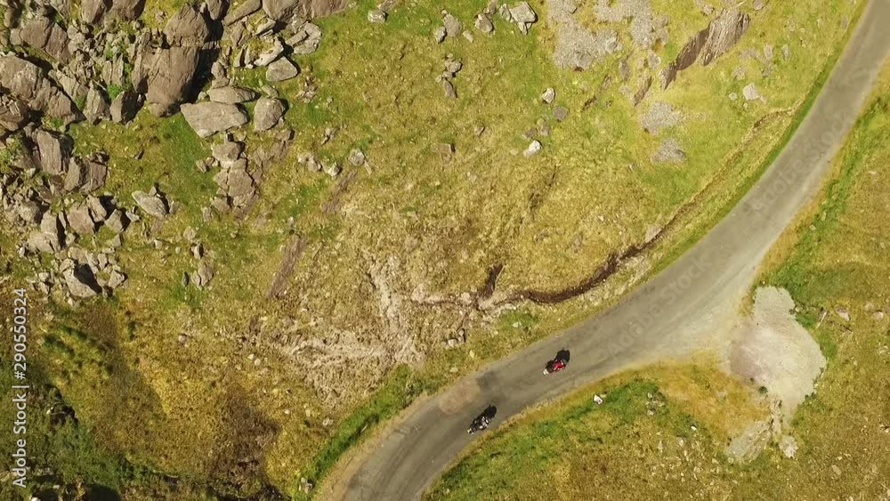 Overhead aerial, bikers on windy road in Ireland Overhead aerial, bikers on windy road in Ireland