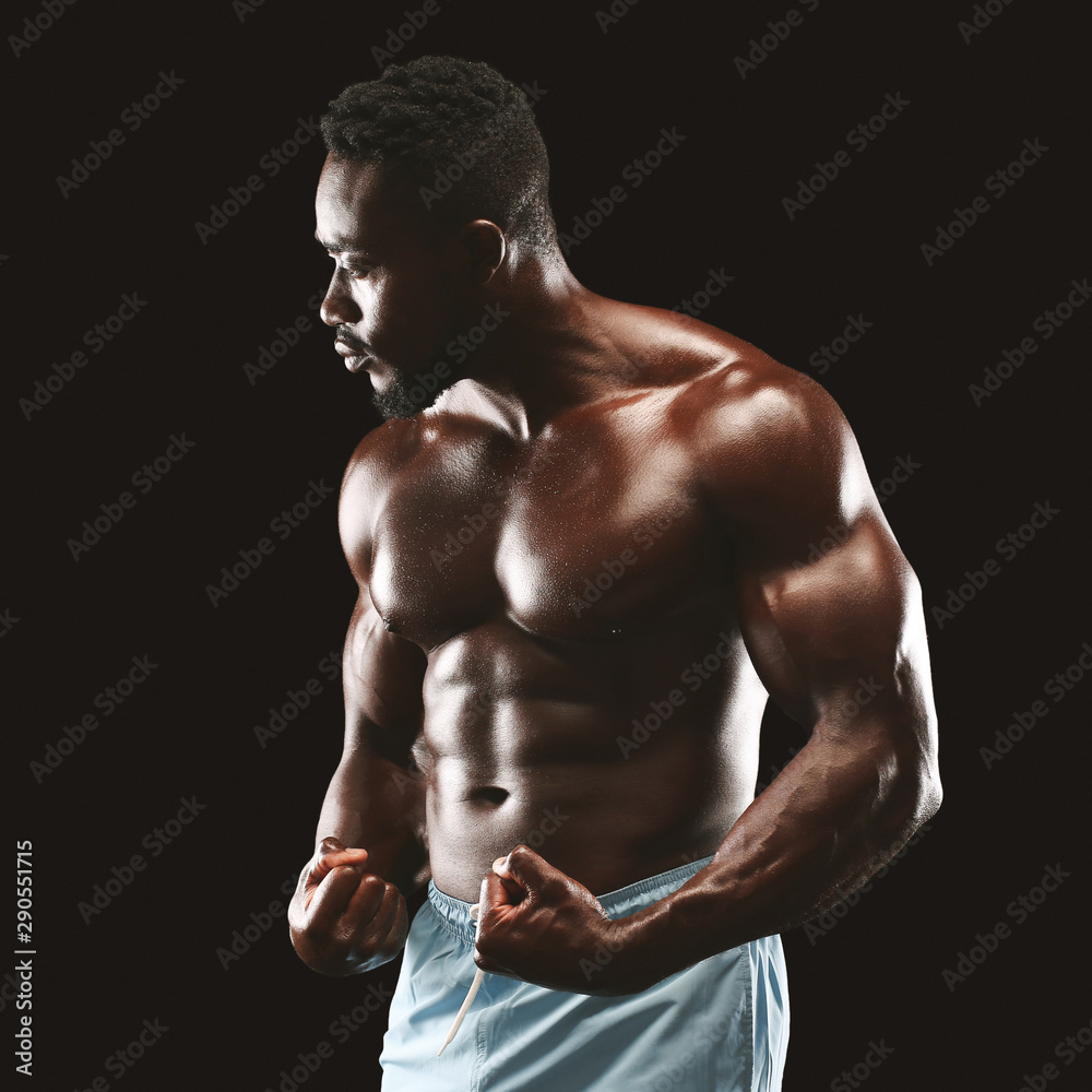 Fototapeta premium Handsome african fittness model displaying his abdominals