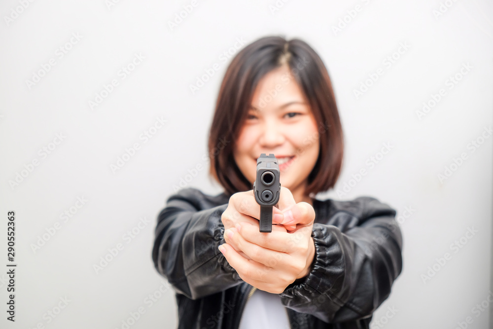Black shirt women aiming gun to audience on white background Black shirt women aiming gun to audience on white background
