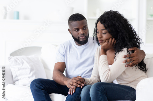 Caring husband comforting his upset wife after hard day