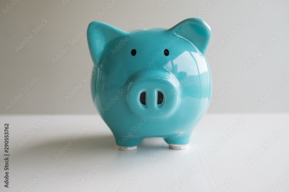 Blue piggy bank with white background, step up growing business to success and saving for retirement concept