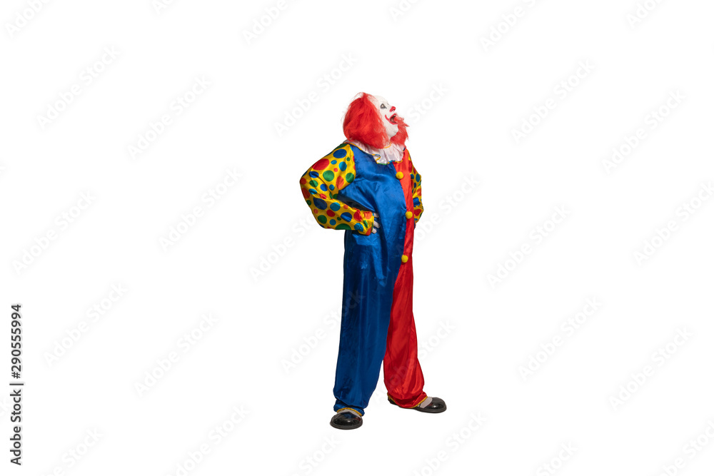 a funny clown with costume and makeup looks to the side