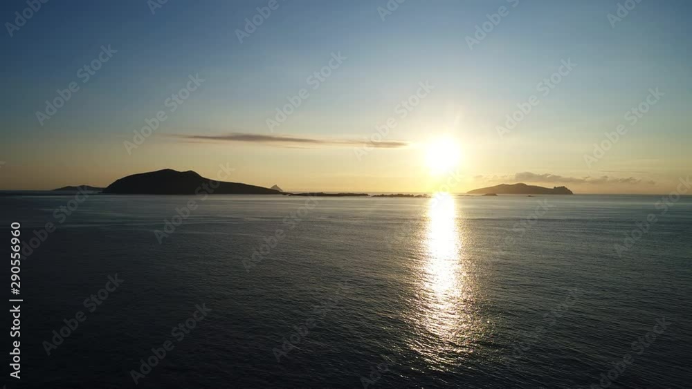 Sun sets over horizon in Dunquin Pier, wide aerial Sun sets over horizon in Dunquin Pier, wide aerial