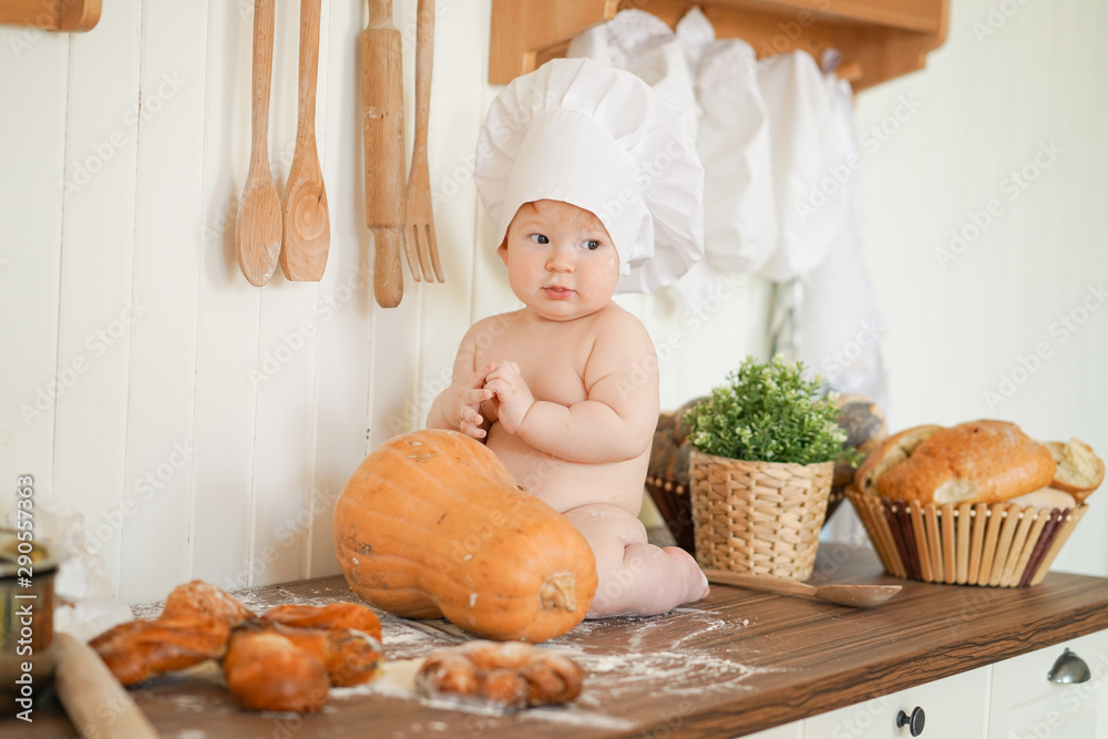 little baker child in chef hat at kitchen table alone little baker child in chef hat at kitchen table alone